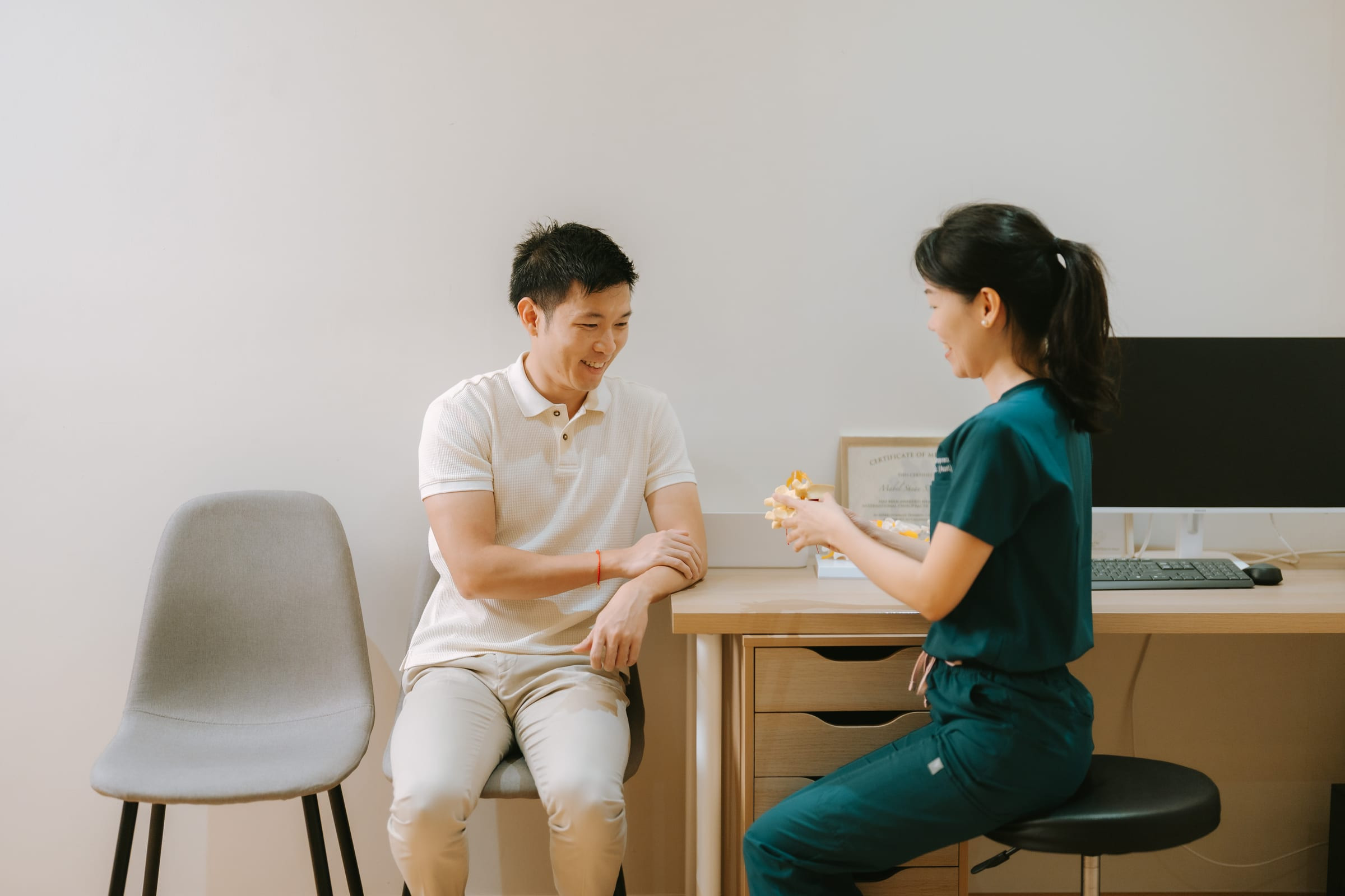 Patient education and results review at family chiropractic clinic