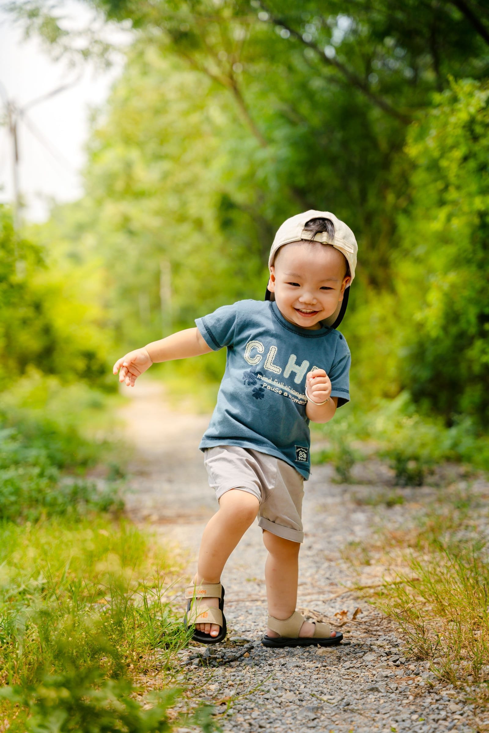 A toddler walking along a garden path