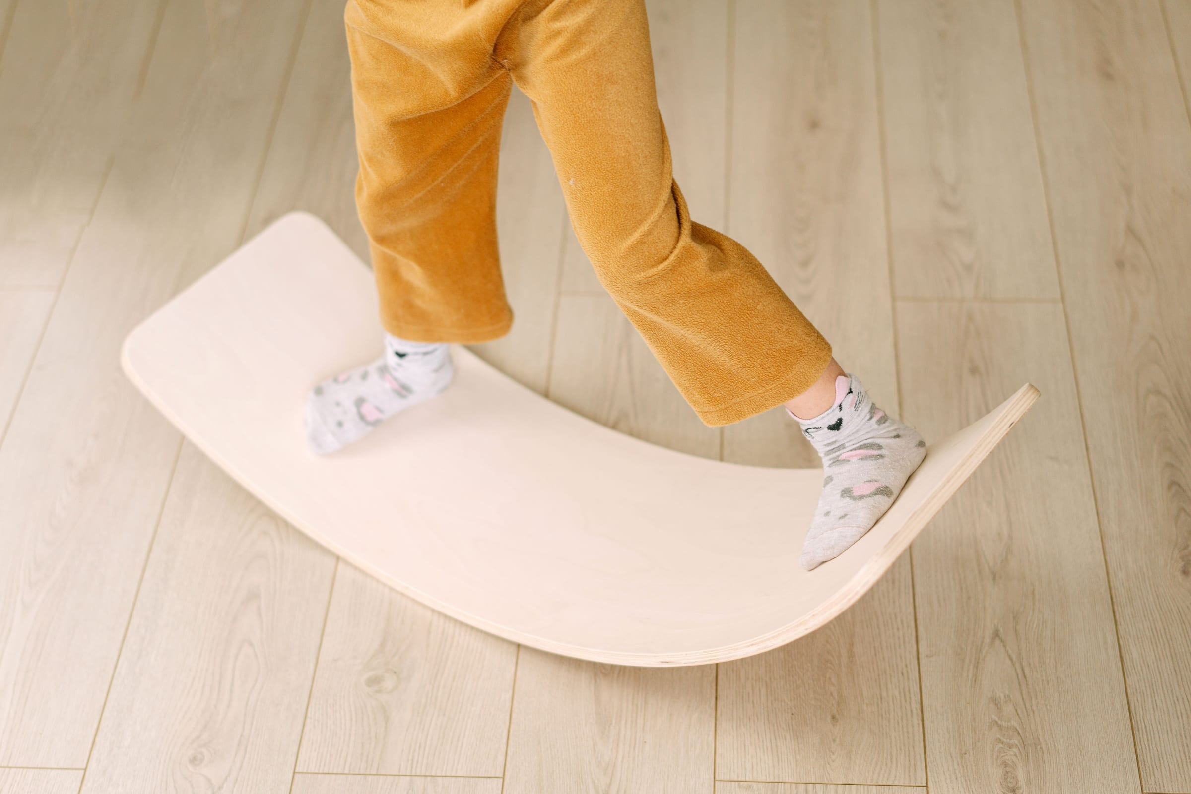 A toddler reaching into a toy box during play