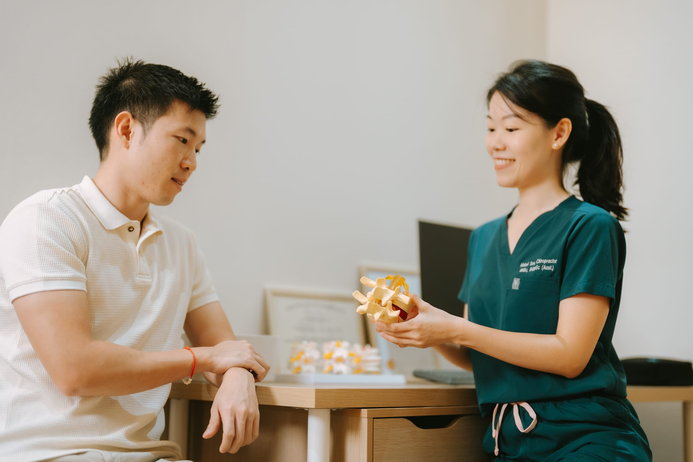 Chiropractor assessing a patient with neck pain and headaches